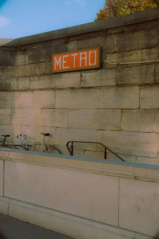 bicycles and bicycle parked in front of the metro entrance