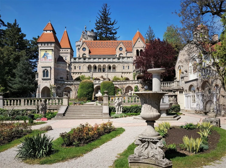 the garden and surrounding area is decorated with stonework and trees