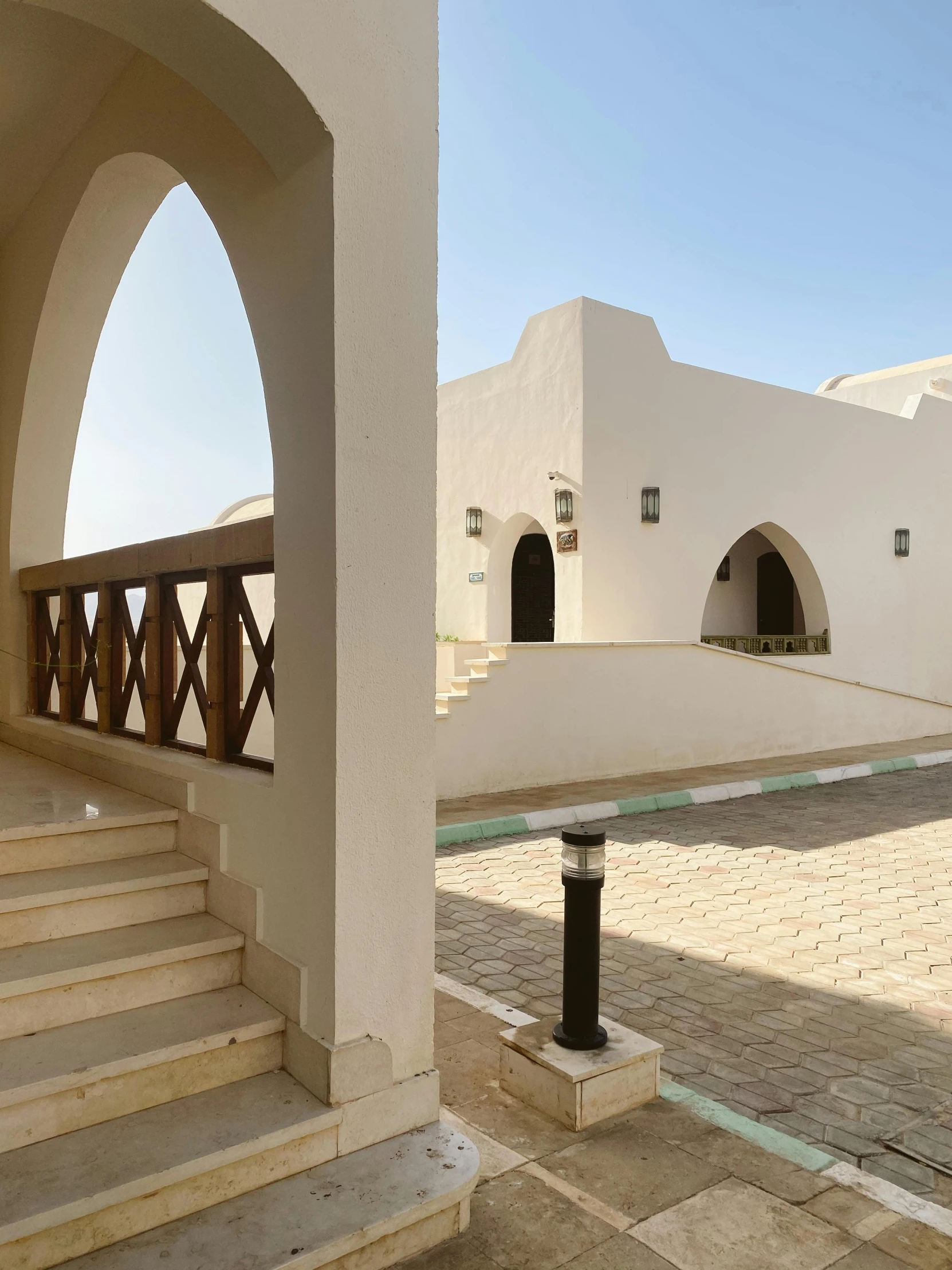 an open area with stairs and small white buildings