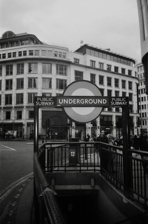 a building with an underground subway sign hanging off the side