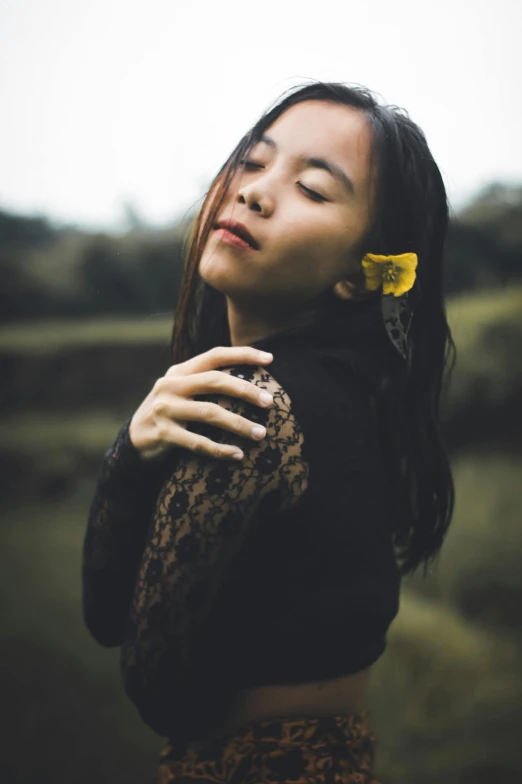 a woman with a yellow flower in her hair