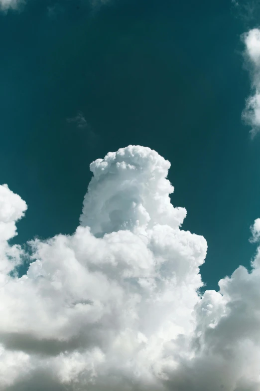 white fluffy clouds fill the sky over buildings