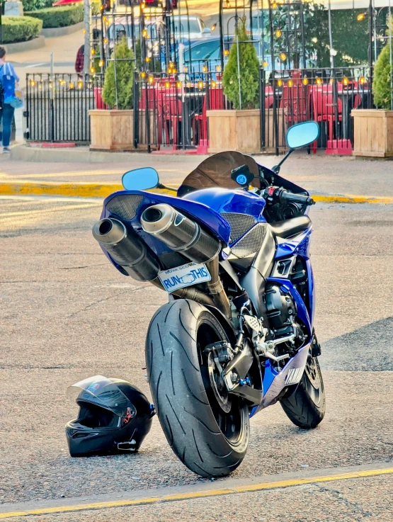 there is a motorcycle parked on the road with a helmet around its knee