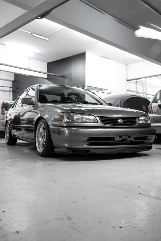 the three cars in the parking garage are parked