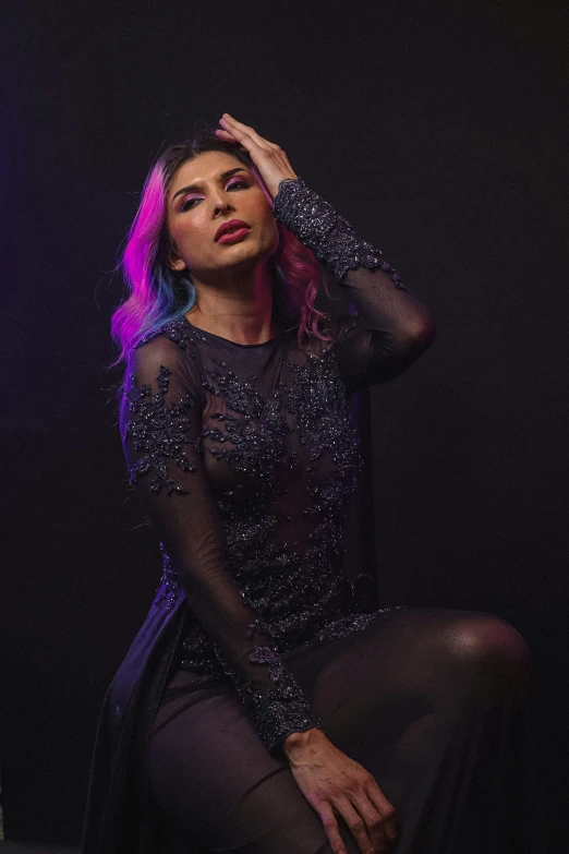 a young woman wearing black sheer clothing posing for the camera