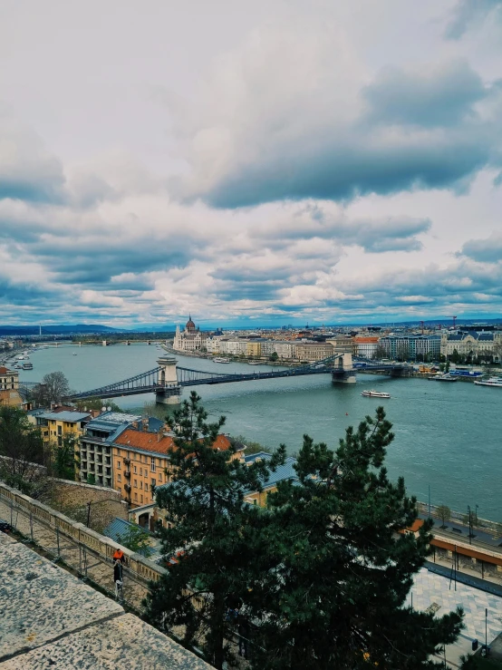 an aerial view of the river and bridge,