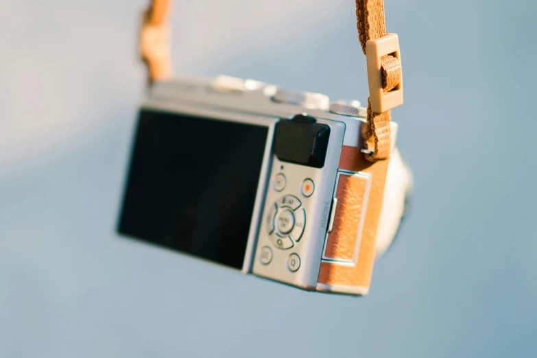 a close up po of a camera hanging in the air