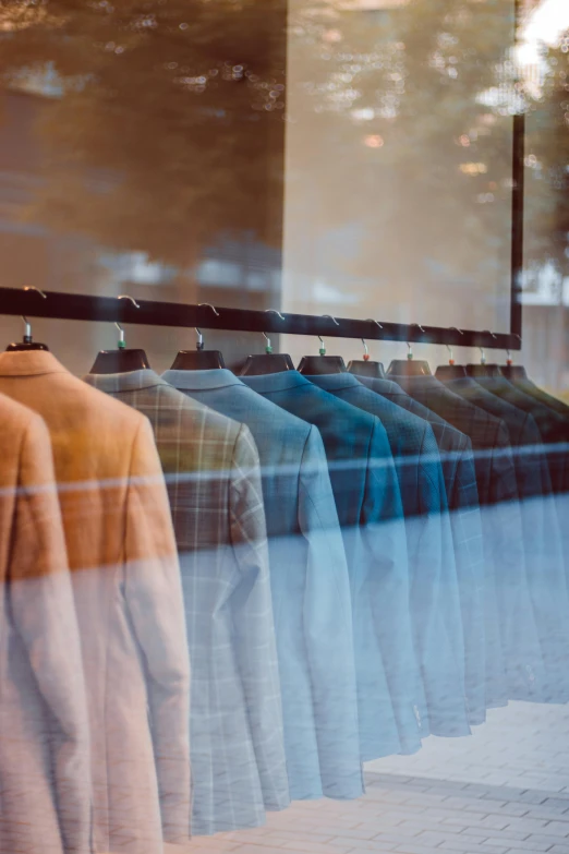 shirts are seen behind the glass display