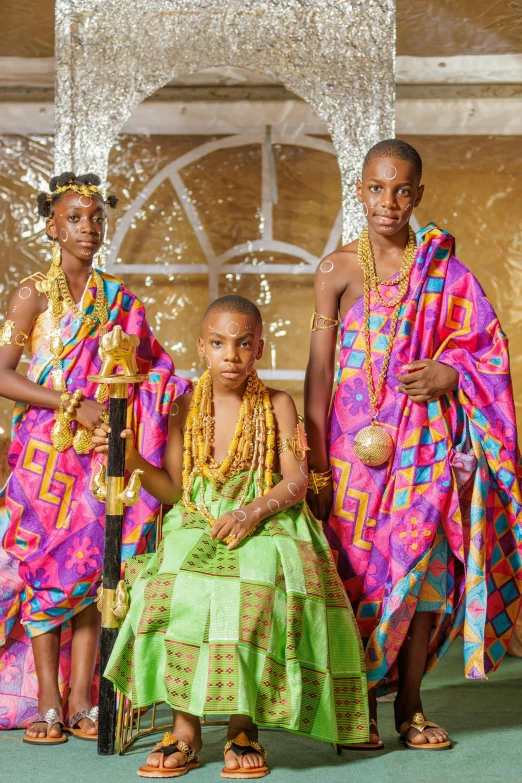 two black girls and their friend in traditional attire