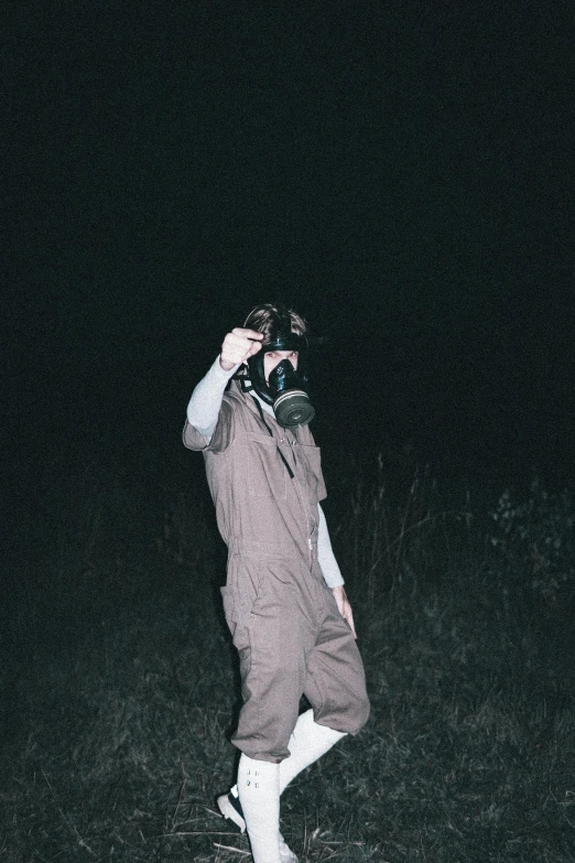a man in snowsuit taking a picture in the dark