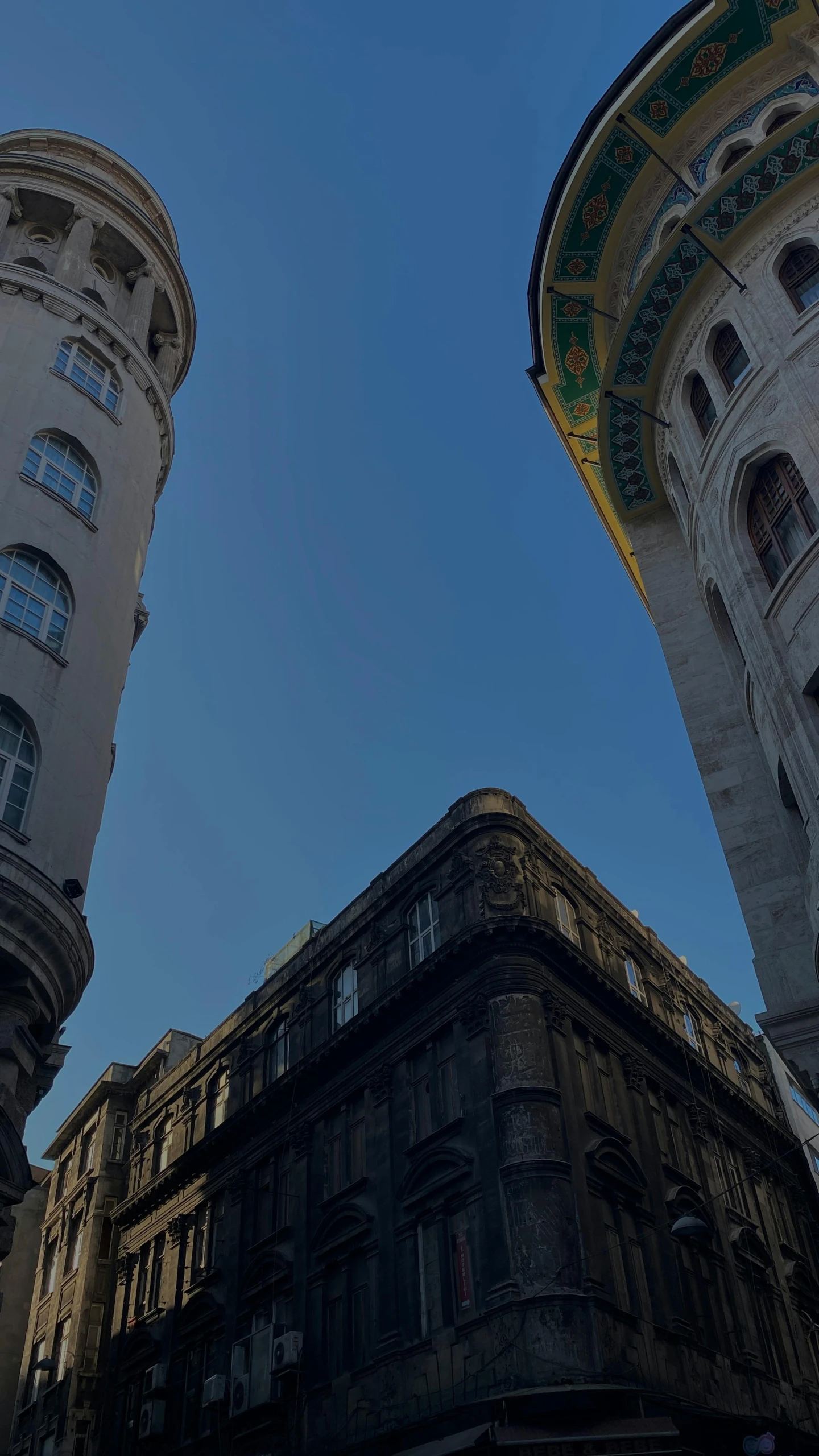 two tall buildings towering in the air on a sunny day