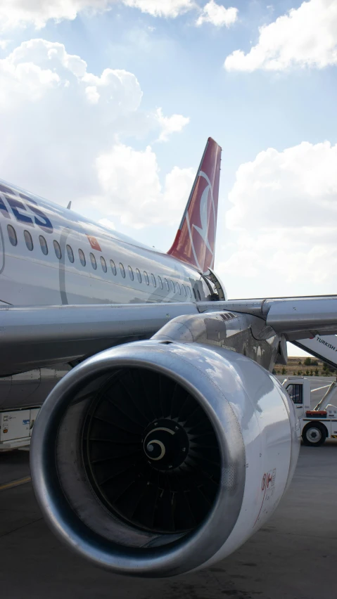 an airplane parked at the gate with its tail end visible