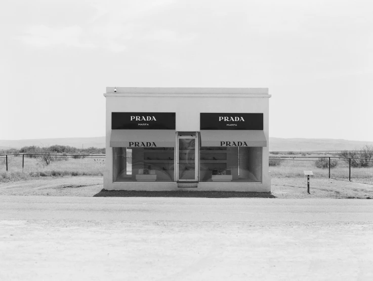 an old gas station sitting next to a fence