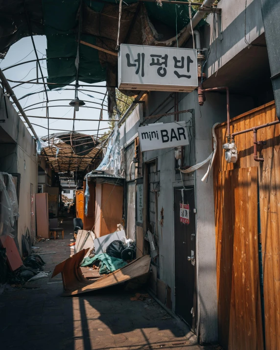 a street with a bunch of wooden doors and tables