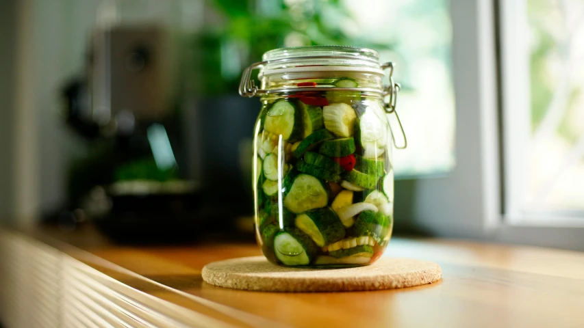 jar full of pickled vegetables on top of table