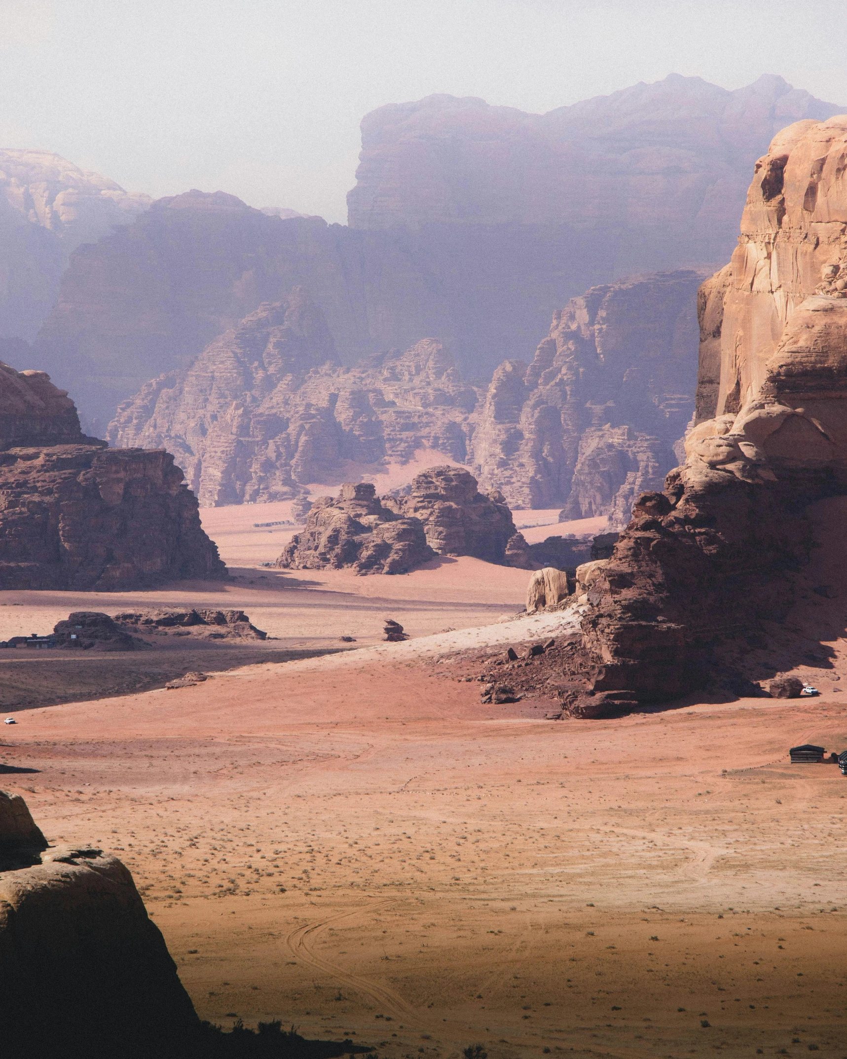 some rocks and dirt near mountains in the desert