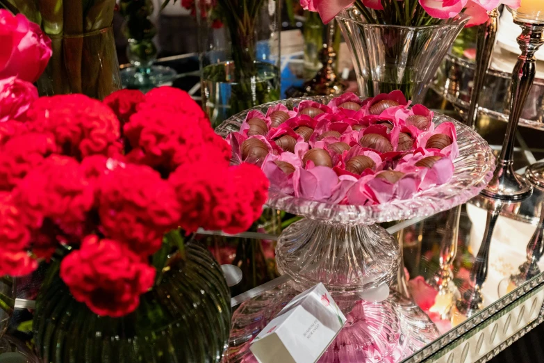 a display with red flowers and chocolates