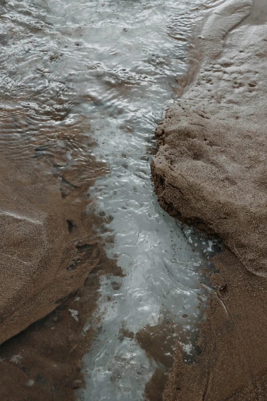 a view of the water's edge from the shore