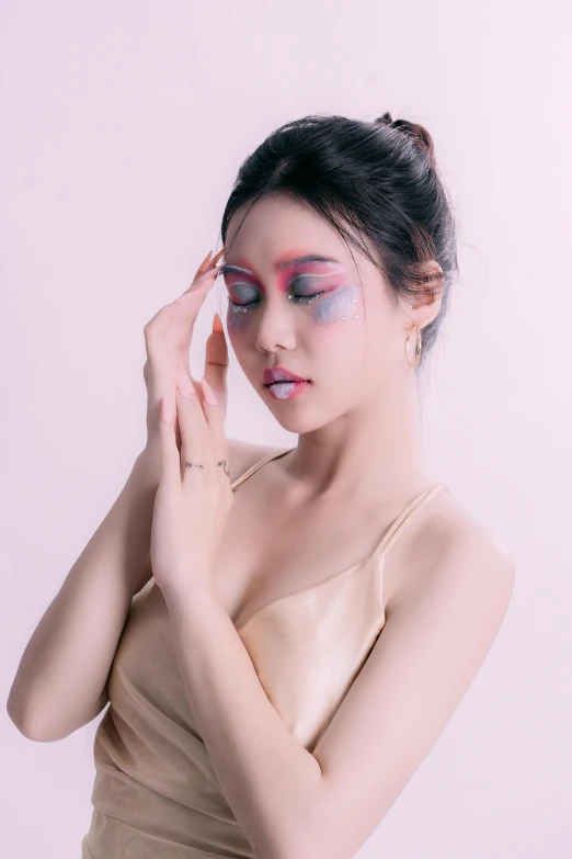 a woman with blue and pink eyeliners posing in a  outfit