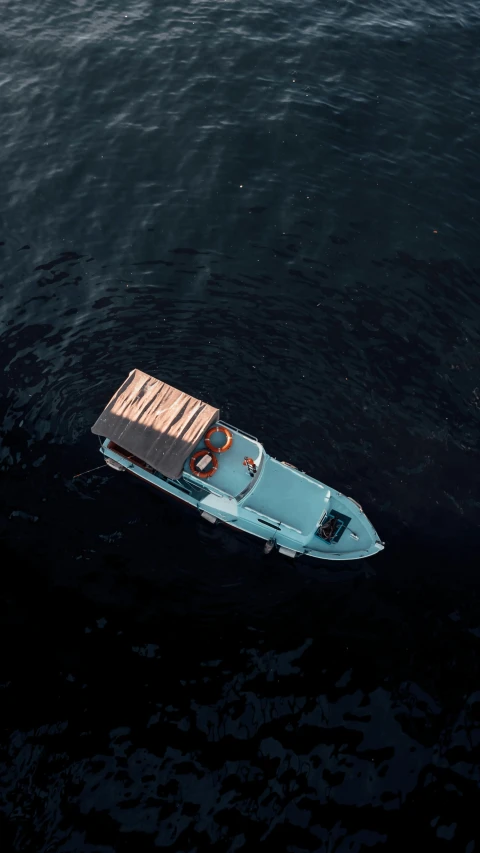 small boat floating in the middle of water