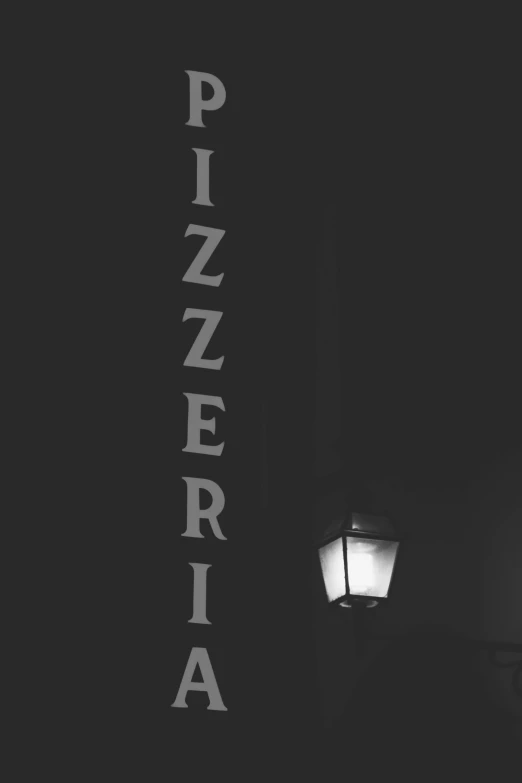 a lamppost with white writing and a black background