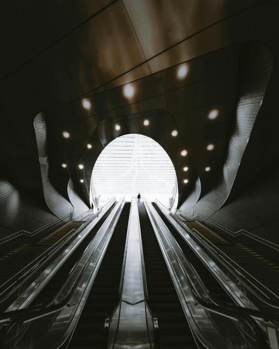 an escalator in a building with the lights turned on