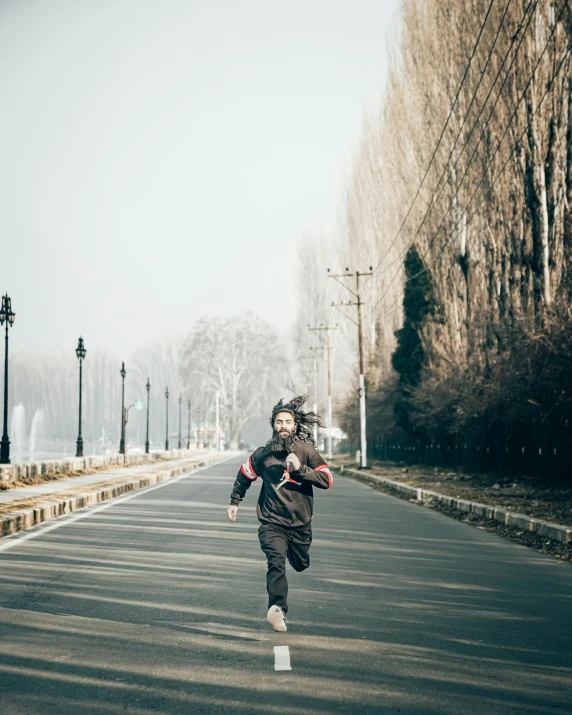 person running down road on a very cold winter day