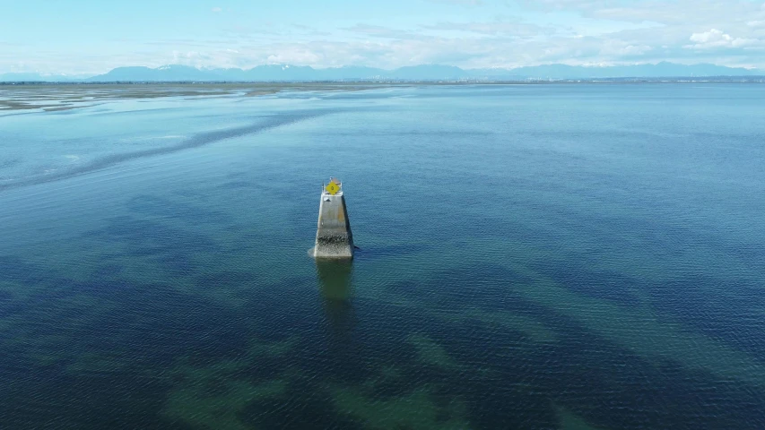 a sign at the end of a dock in some water