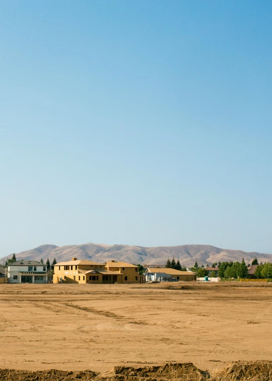 an old building in the desert is yellow