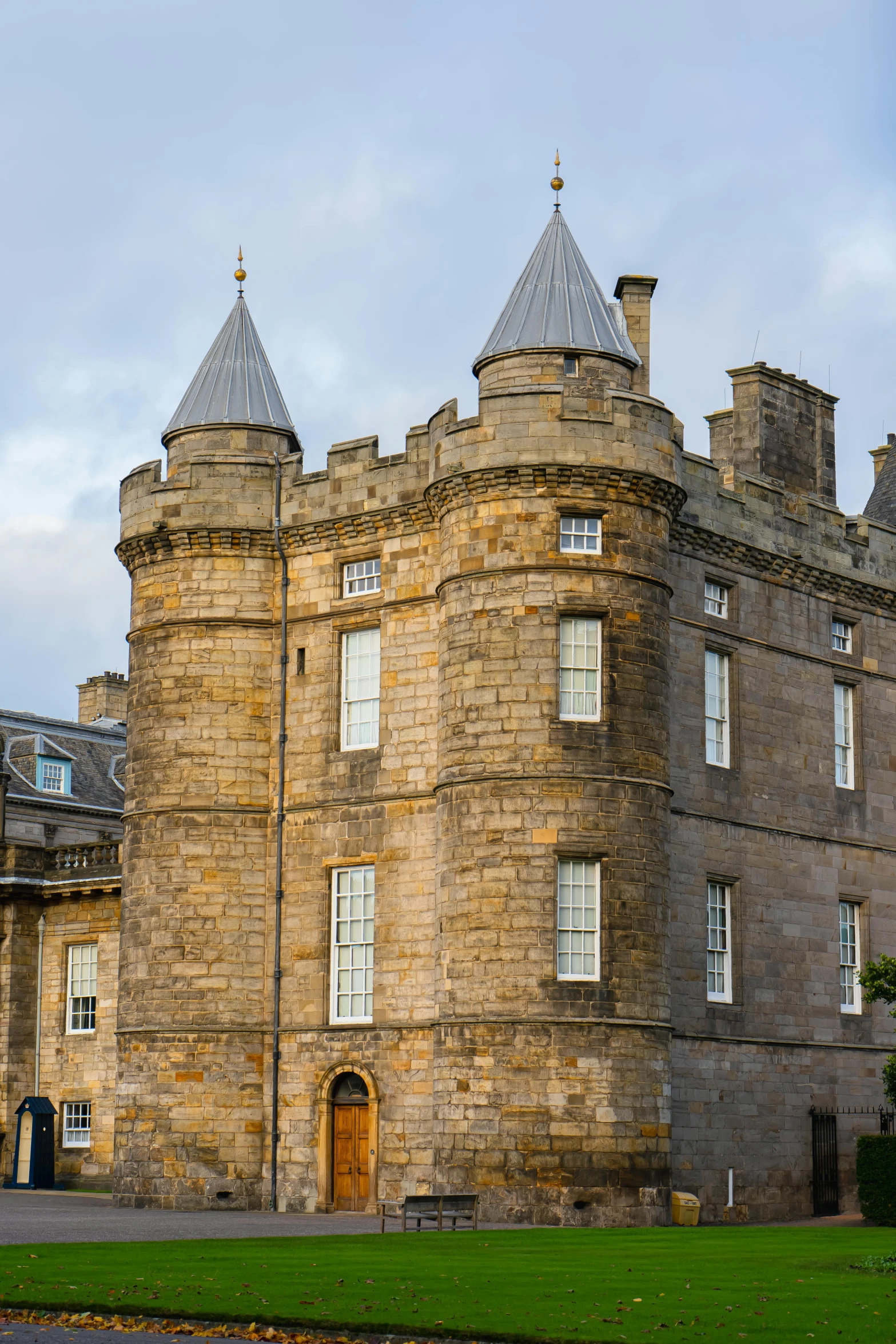 an old stone building with two towers and a tall door