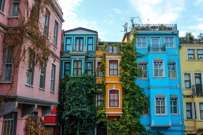 colorful buildings are lining the corner of a narrow street