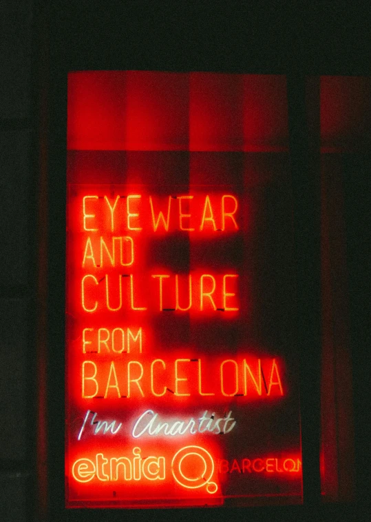 a neon sign on the side of a street