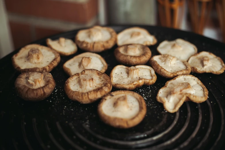 cooked mushrooms cooking on a charcoal grill