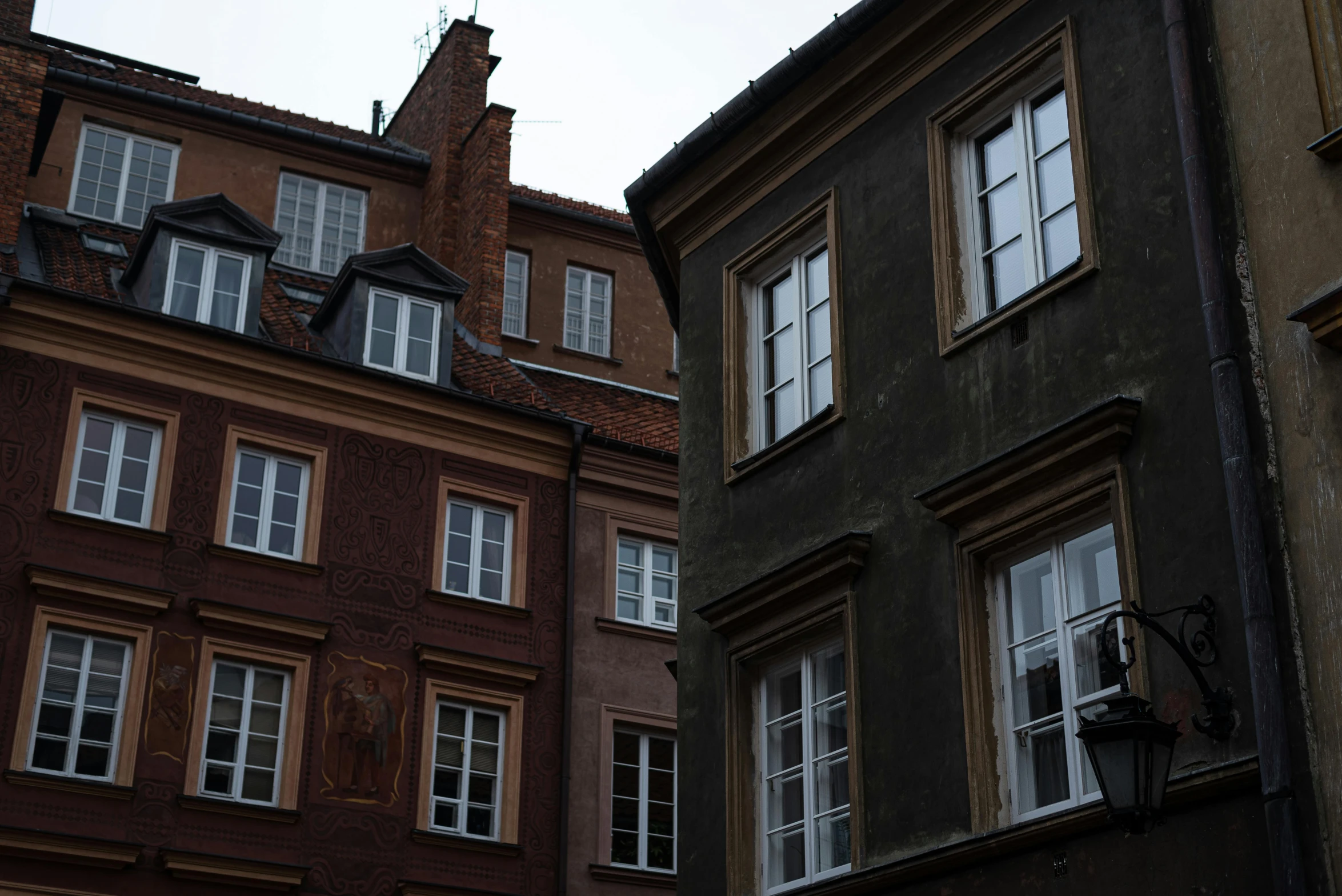 the top of two buildings have windows on the upper floor