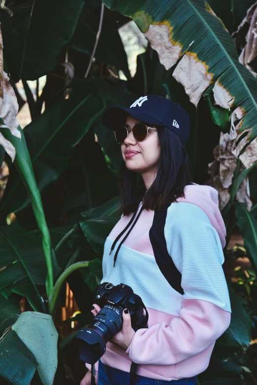 a woman holding her camera and posing for the camera