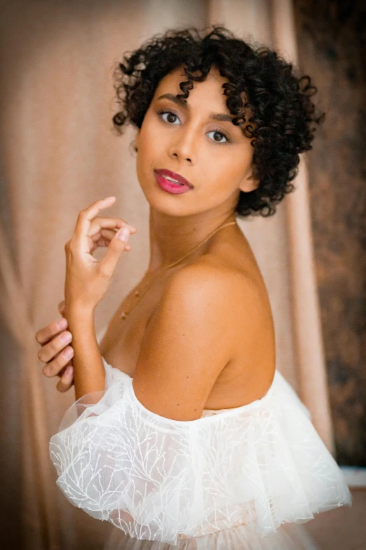 a young woman in a white skirt is staring at the camera