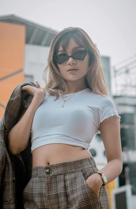 a young woman is holding her jacket near the camera