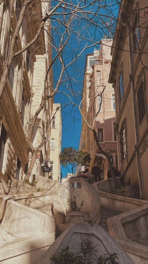 two statues stand near a set of buildings