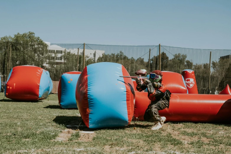 two large blue and red inflated objects in the grass