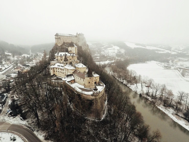 an aerial s of a castle with trees covered in snow