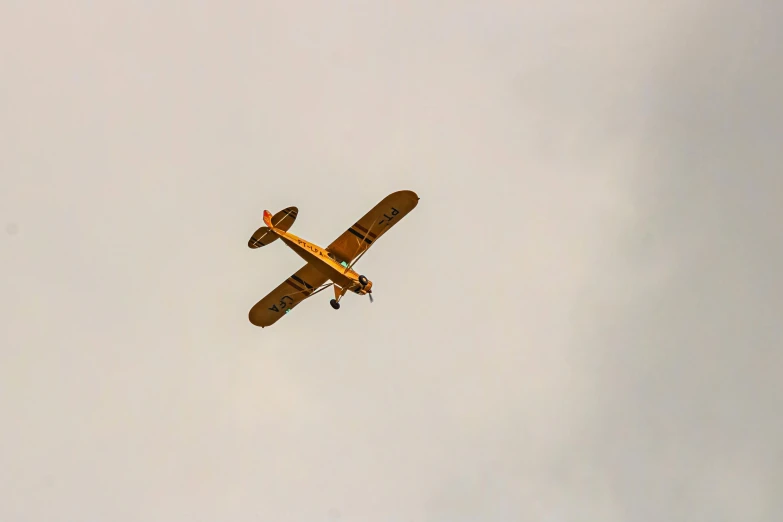 an airplane flying against a gray sky