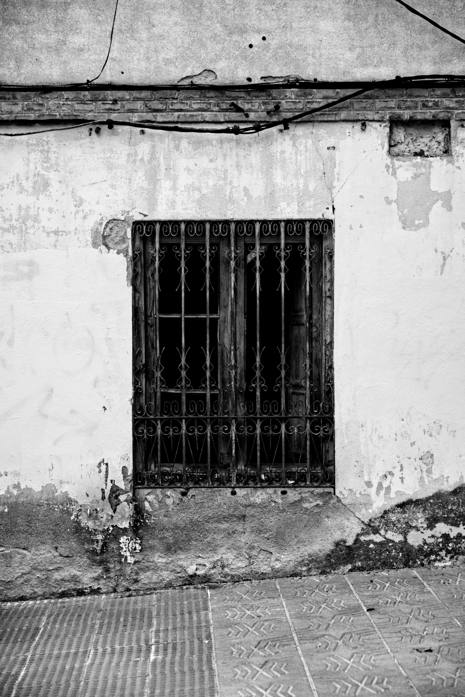 the side of an old building with an iron door