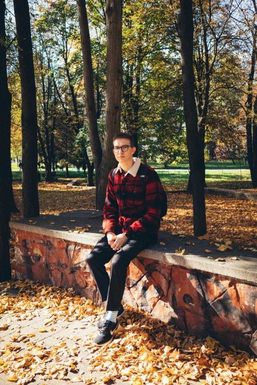 a person sitting on top of a stone bench