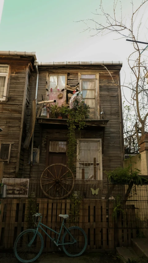 a bicycle parked outside of a wooden house