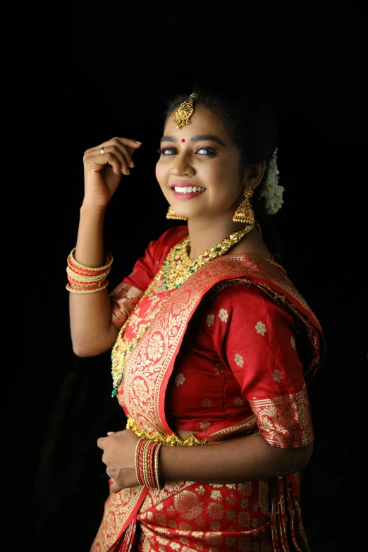 a woman in a red and gold sari