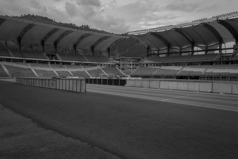 an empty field next to an empty stadium