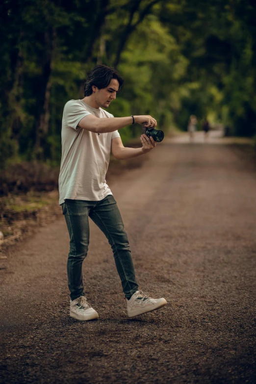 a man standing in the middle of the road while holding a baseball mitt