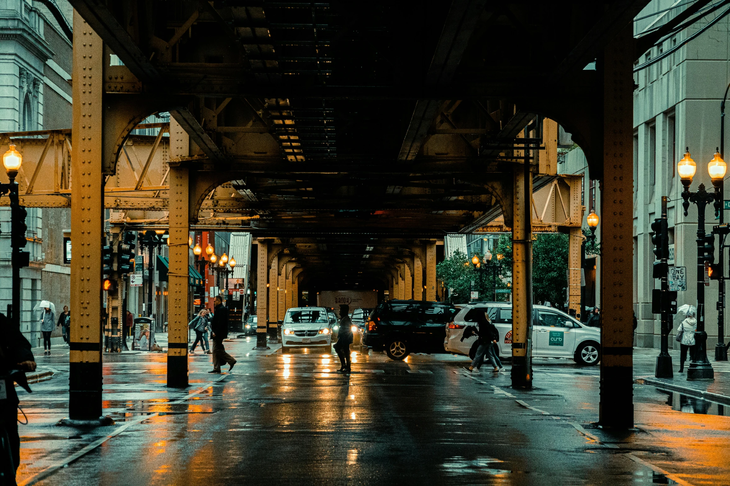 people and cars are traveling on an empty street