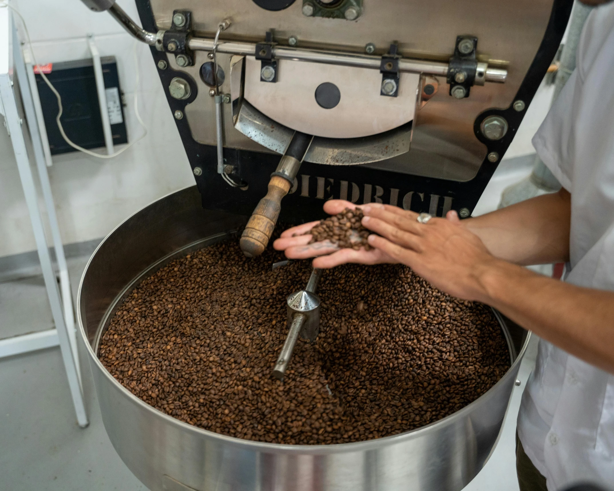 a person filling coffee into a machine on a table