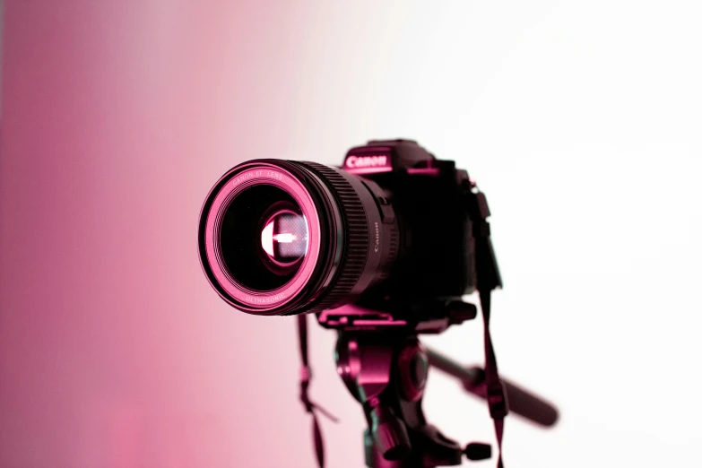 a camera lens on the ground in front of a white wall